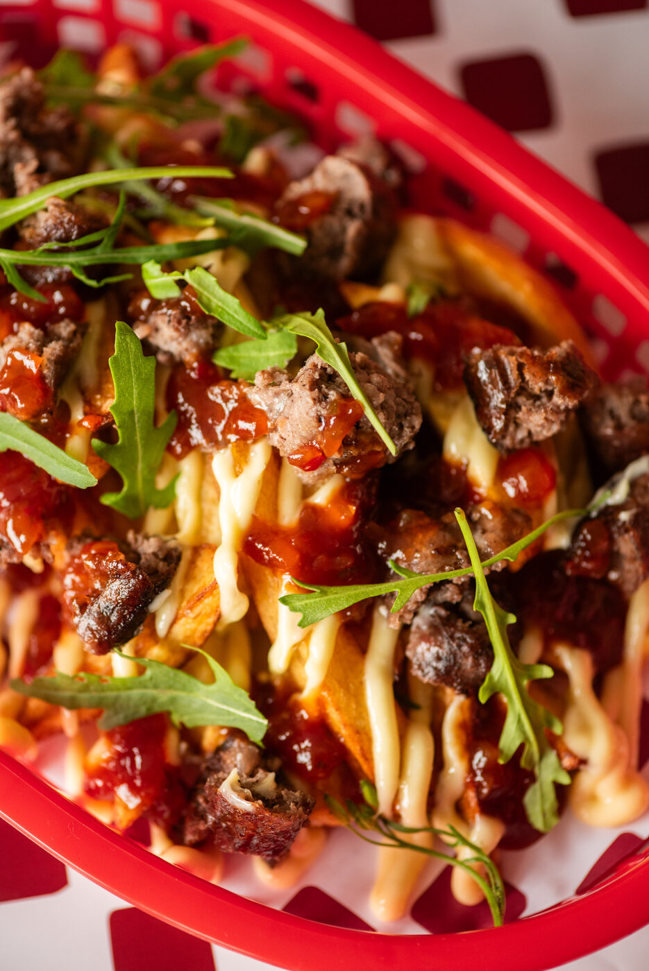 Close up of BURI loaded fries with boerewors chunks and rocket